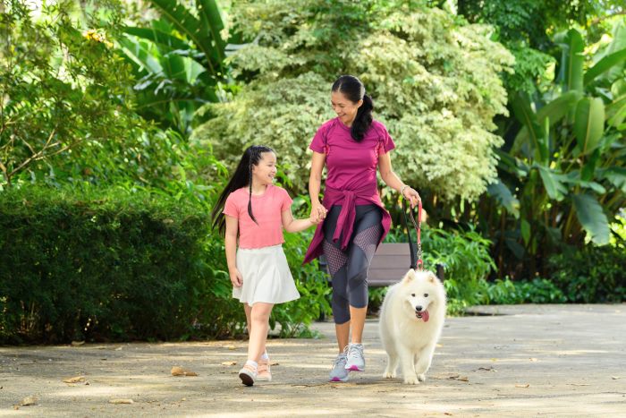 mother and daughter walking dog